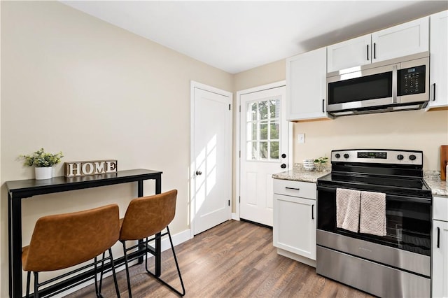 4649 Rolling Hills Rd, Whitehall, PA 15236 - kitchen with appliances with stainless steel finishes, dark wood-type flooring, white cabinets, and light stone countertops