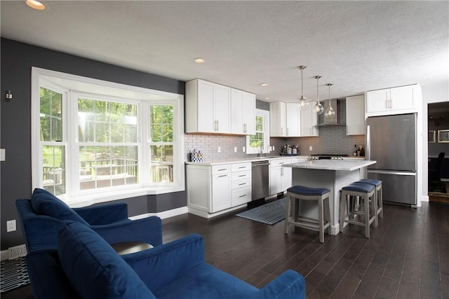 407 Highland Ct, Marshall, PA 15090 - kitchen featuring stainless steel appliances, wall chimney exhaust hood, light countertops, a breakfast bar, and white cabinets