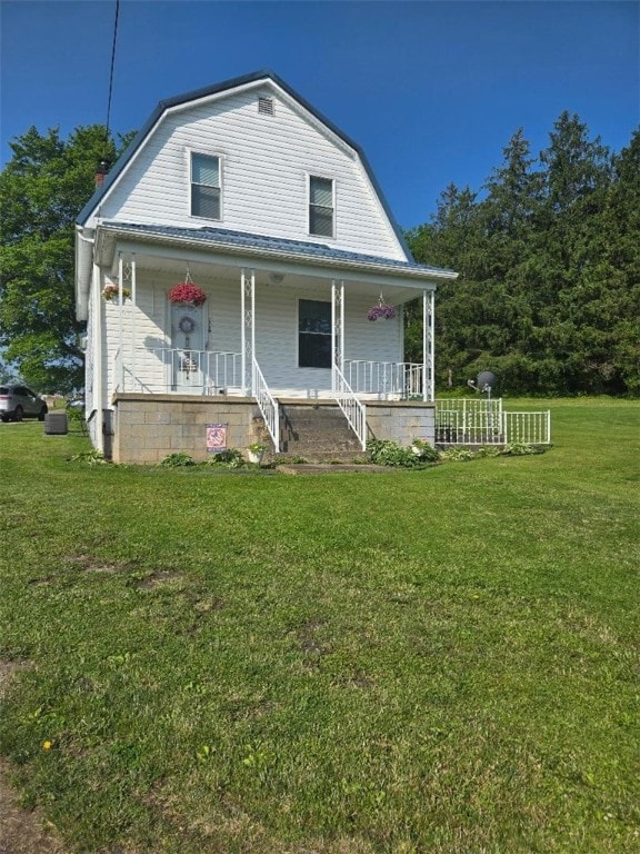 114 Dry Knob Rd, Georges Twp, PA 15478 - colonial inspired home with a gambrel roof, a porch, a front yard, and stairs