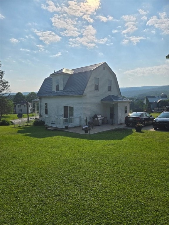 114 Dry Knob Rd, Georges Twp, PA 15478 - back of property with a gambrel roof, a patio area, metal roof, and a yard