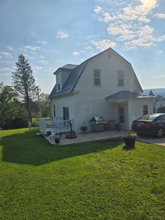 114 Dry Knob Rd, Georges Twp, PA 15478 - rear view of property featuring a patio area, a lawn, a gambrel roof, and metal roof