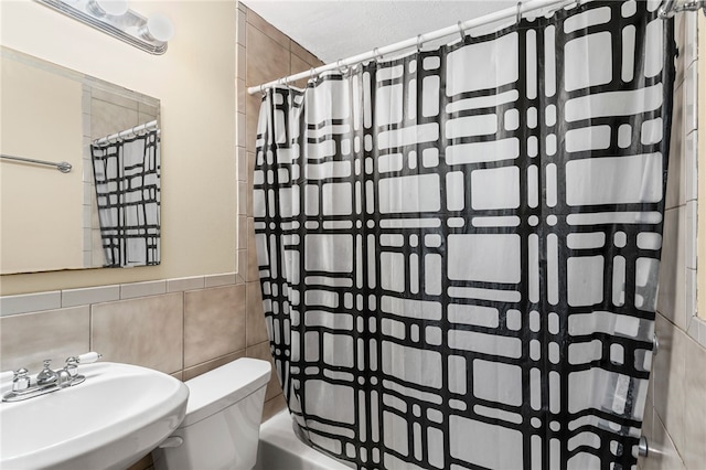 1913 Saint Paul St, South Side, PA 15203 - bathroom featuring a sink, tile walls, toilet, and shower / bath combo