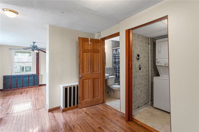 1913 Saint Paul St, South Side, PA 15203 - corridor with stacked washer / dryer and wood-type flooring