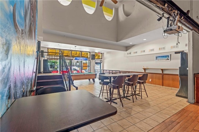 2512 E Carson St, South Side, PA 15203 - dining space featuring light tile patterned flooring, pool table, a high ceiling, and a ceiling fan