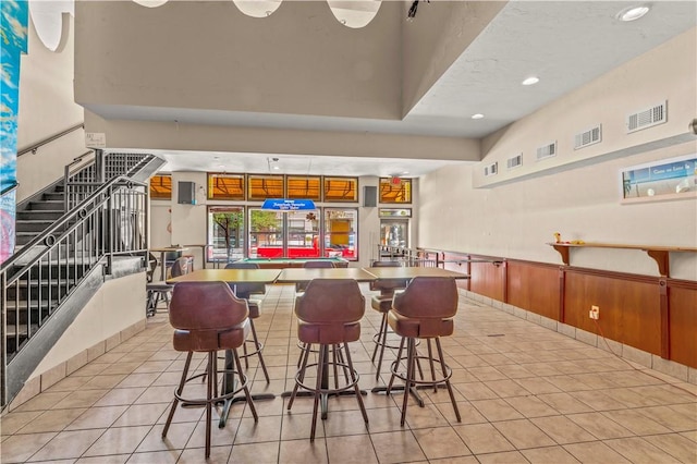 2512 E Carson St, South Side, PA 15203 - community bar area with light tile patterned floors, stairs, wainscoting, and recessed lighting