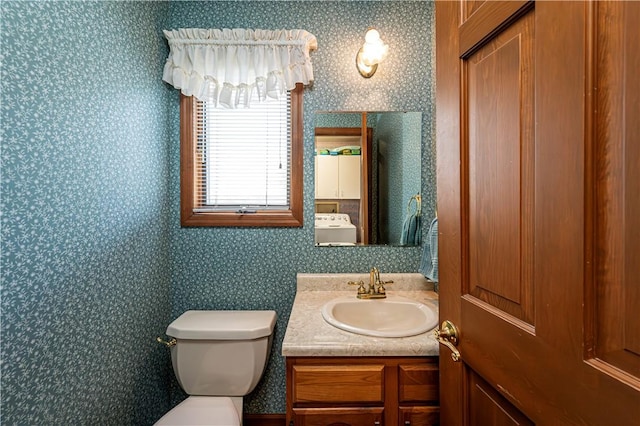 28 Saddlebrook Dr, Hempfield Twp Wml, PA 15601 - half bath with washer / clothes dryer, vanity, toilet, and wallpapered walls