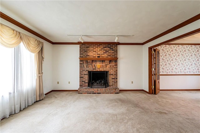 28 Saddlebrook Dr, Hempfield Twp Wml, PA 15601 - unfurnished living room featuring carpet flooring, a brick fireplace, rail lighting, ornamental molding, and wainscoting