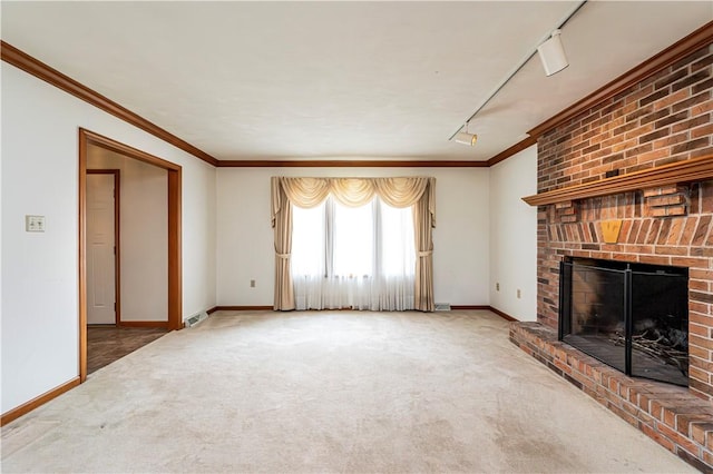28 Saddlebrook Dr, Hempfield Twp Wml, PA 15601 - unfurnished living room with carpet floors, rail lighting, a brick fireplace, baseboards, and crown molding