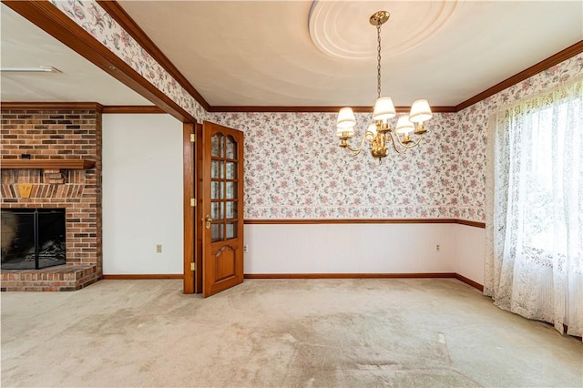 28 Saddlebrook Dr, Hempfield Twp Wml, PA 15601 - unfurnished dining area with crown molding, wainscoting, a chandelier, carpet floors, and wallpapered walls