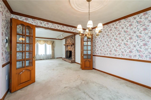 28 Saddlebrook Dr, Hempfield Twp Wml, PA 15601 - unfurnished living room with ornamental molding, wallpapered walls, a chandelier, baseboards, and a brick fireplace