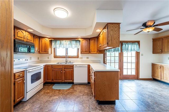 28 Saddlebrook Dr, Hempfield Twp Wml, PA 15601 - kitchen with white appliances, a sink, brown cabinets, a peninsula, and recessed lighting