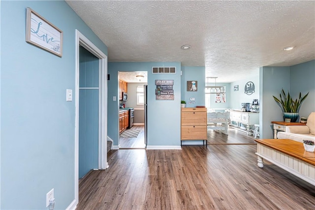 1941 Ivanhoe Dr, North Huntingdon, PA 15642 - living area with wood finished floors, a textured ceiling, and baseboards