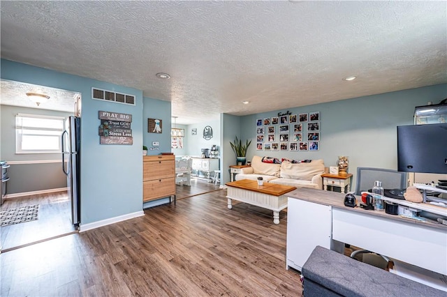 1941 Ivanhoe Dr, North Huntingdon, PA 15642 - living area with wood finished floors, a textured ceiling, recessed lighting, and baseboards