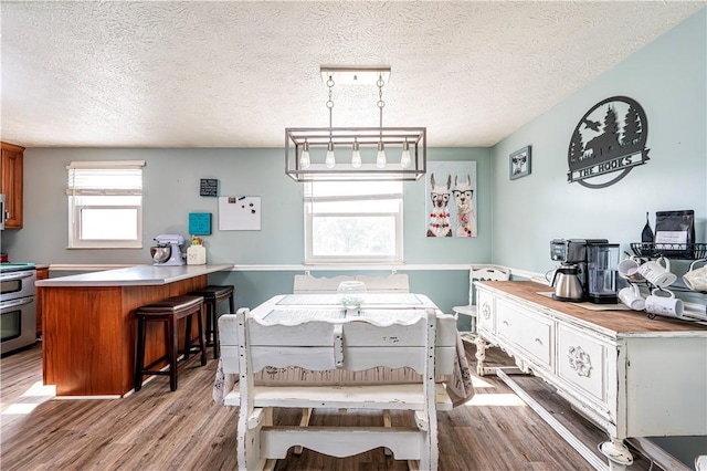 1941 Ivanhoe Dr, North Huntingdon, PA 15642 - dining area with light wood-style floors and a textured ceiling