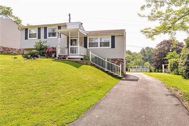 1941 Ivanhoe Dr, North Huntingdon, PA 15642 - tri-level home featuring asphalt driveway, a front yard, and brick siding