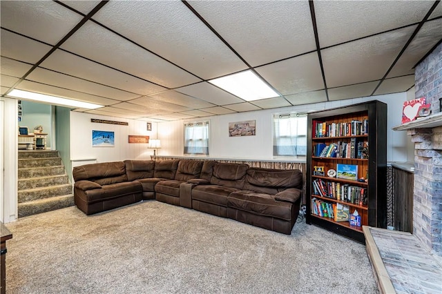 1941 Ivanhoe Dr, North Huntingdon, PA 15642 - carpeted living room with a drop ceiling, a fireplace, and stairway