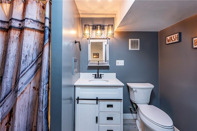 1941 Ivanhoe Dr, North Huntingdon, PA 15642 - bathroom featuring toilet, vanity, and baseboards