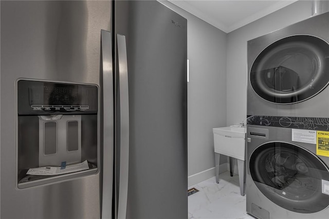 615 Cliff Ave, Bellevue, PA 15202 - laundry area featuring stacked washer and clothes dryer, marble look tile flooring, and ornamental molding