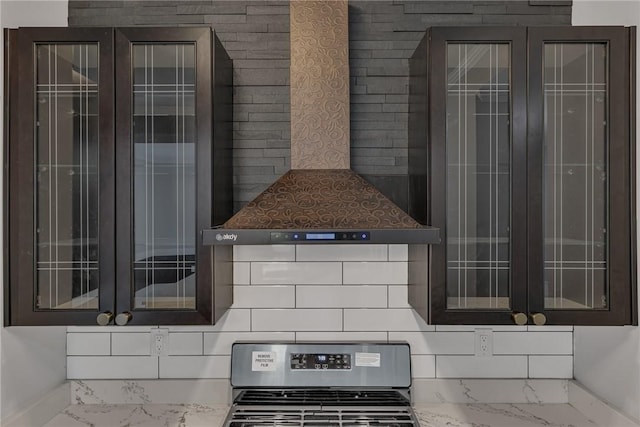 615 Cliff Ave, Bellevue, PA 15202 - kitchen featuring stainless steel gas range oven, marble finish flooring, glass insert cabinets, wall chimney exhaust hood, and backsplash