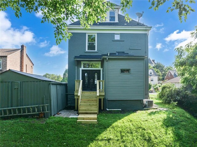 615 Cliff Ave, Bellevue, PA 15202 - rear view of house featuring a lawn, french doors, a storage unit, and brick siding