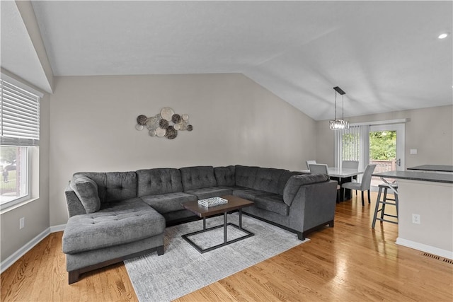 509 Cresthaven Dr, Plum Boro, PA 15239 - living area featuring lofted ceiling, light wood finished floors, baseboards, and a chandelier