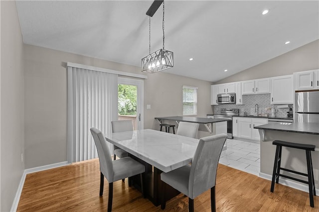 509 Cresthaven Dr, Plum Boro, PA 15239 - dining room with lofted ceiling, light wood-style floors, recessed lighting, and baseboards