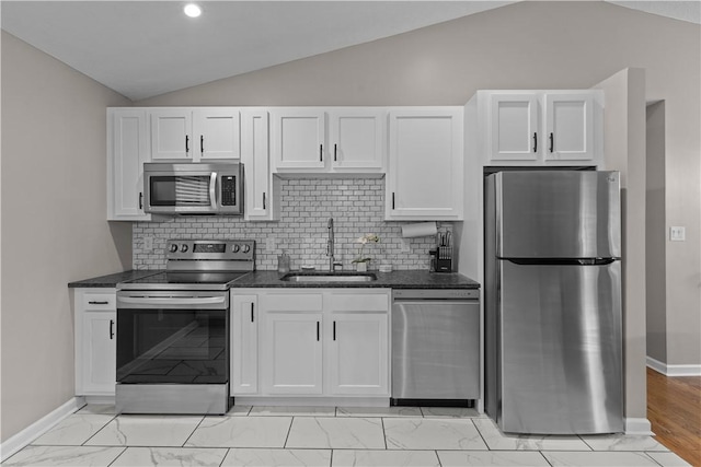 509 Cresthaven Dr, Plum Boro, PA 15239 - kitchen featuring appliances with stainless steel finishes, a sink, lofted ceiling, light marble finish flooring, and white cabinets