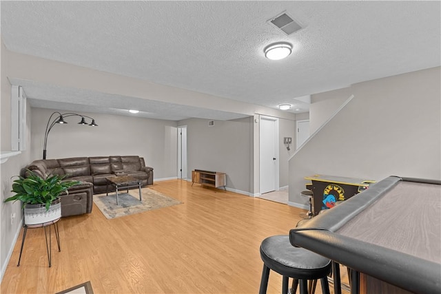 509 Cresthaven Dr, Plum Boro, PA 15239 - living area featuring wood finished floors, a textured ceiling, baseboards, and stairs