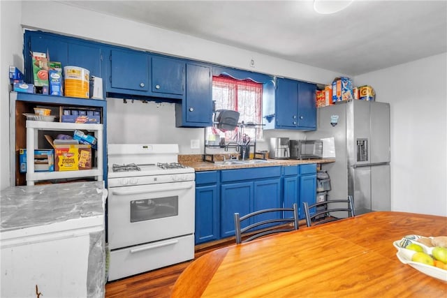 439 Ford St, West Mifflin, PA 15122 - kitchen featuring gas range gas stove, blue cabinetry, a sink, and stainless steel refrigerator with ice dispenser