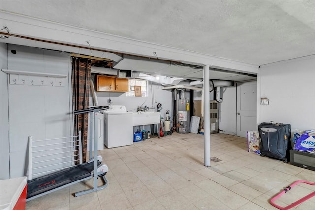 439 Ford St, West Mifflin, PA 15122 - below grade area featuring a sink, water heater, separate washer and dryer, light floors, and a textured ceiling