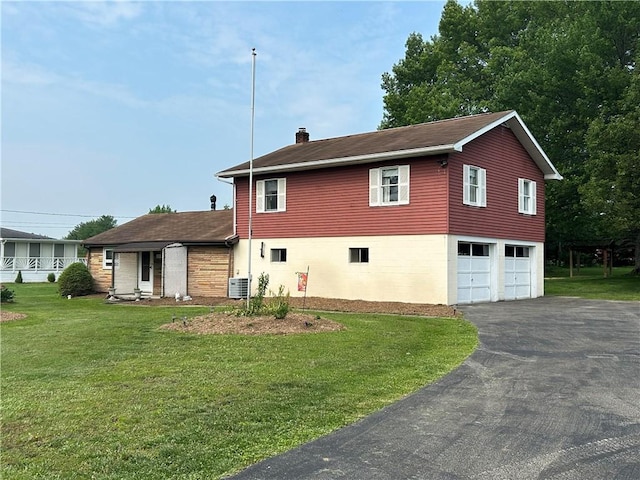 1214 Ridge Blvd, Dunbar Twp, PA 15425 - view of front of property with a chimney, driveway, central AC, and a front lawn