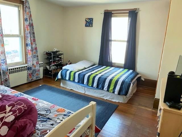 22 Lemon St, Uniontown, PA 15401 - bedroom featuring radiator heating unit and wood finished floors