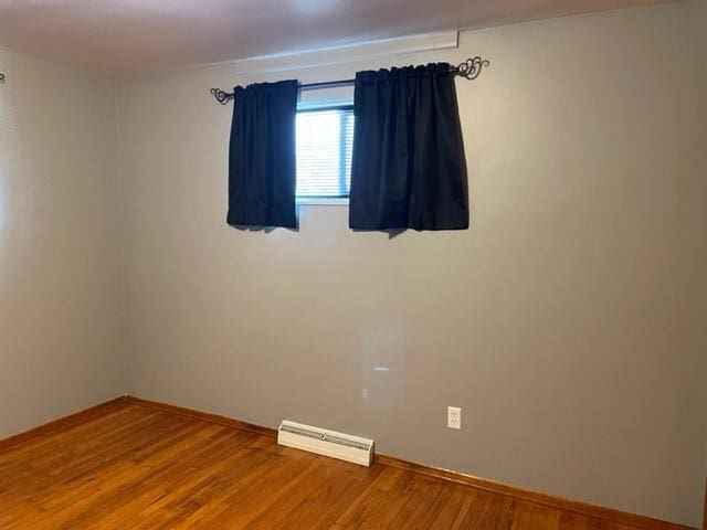 22 Lemon St, Uniontown, PA 15401 - unfurnished room with a baseboard radiator, wood finished floors, and baseboards