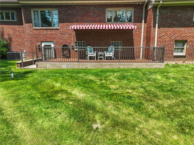 1033 Colvin Dr, Brighton Twp, PA 15009 - rear view of property featuring central air condition unit, brick siding, and a yard