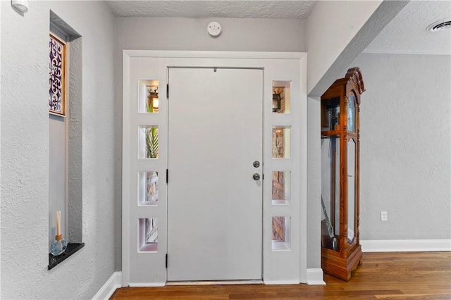 1033 Colvin Dr, Brighton Twp, PA 15009 - foyer entrance featuring wood finished floors, a textured ceiling, and baseboards