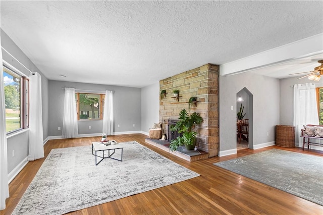 1033 Colvin Dr, Brighton Twp, PA 15009 - living area with a textured ceiling, plenty of natural light, wood finished floors, a ceiling fan, and baseboards