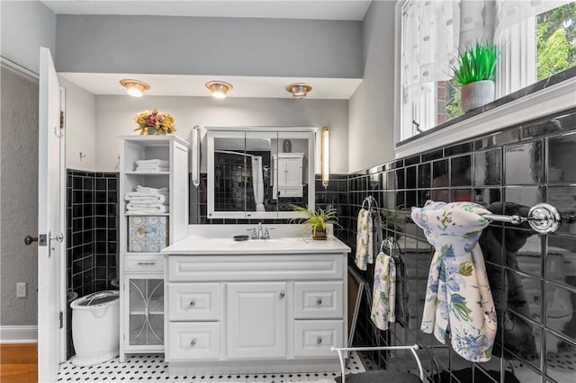 1033 Colvin Dr, Brighton Twp, PA 15009 - bathroom featuring vanity, tile walls, and baseboards