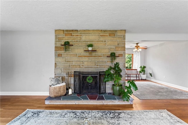 1033 Colvin Dr, Brighton Twp, PA 15009 - living room featuring wood finished floors, baseboards, a textured ceiling, a fireplace, and ceiling fan