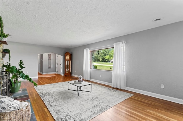 1033 Colvin Dr, Brighton Twp, PA 15009 - living room featuring wood finished floors, baseboards, and a textured ceiling