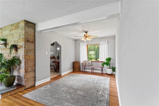 1033 Colvin Dr, Brighton Twp, PA 15009 - living area featuring arched walkways, a textured ceiling, wood finished floors, a ceiling fan, and baseboards