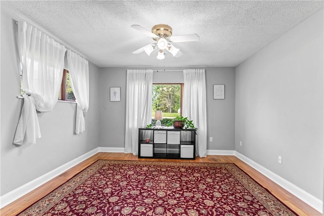1033 Colvin Dr, Brighton Twp, PA 15009 - unfurnished room with wood finished floors, ceiling fan, healthy amount of natural light, a textured ceiling, and baseboards