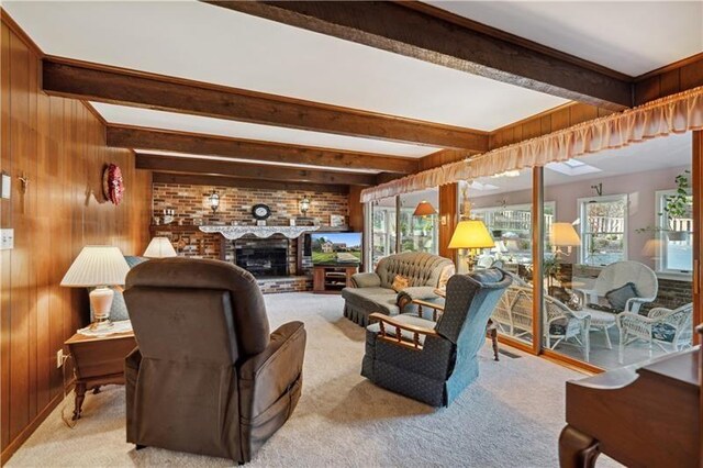 229 Crawford Ln, Rostraver, PA 15012 - carpeted living room with beamed ceiling, wooden walls, and a brick fireplace