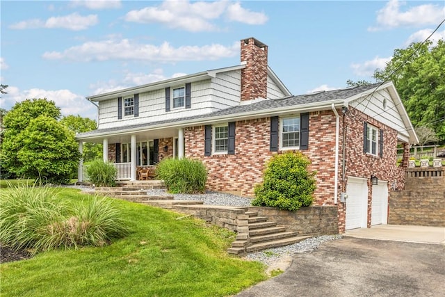 375 Navaho Hollow Rd, Coolbaugh Twp, PA 15438 - view of front of home featuring a chimney, a porch, driveway, an attached garage, and brick siding