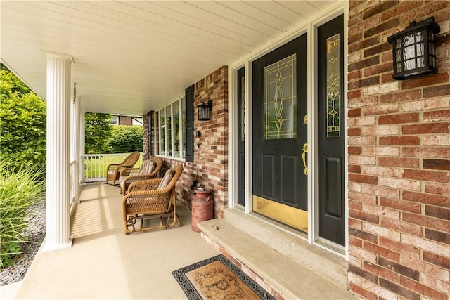 375 Navaho Hollow Rd, Coolbaugh Twp, PA 15438 - view of exterior entry featuring a porch and brick siding