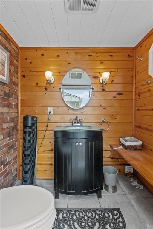 375 Navaho Hollow Rd, Coolbaugh Twp, PA 15438 - half bath with vanity, wooden walls, and toilet