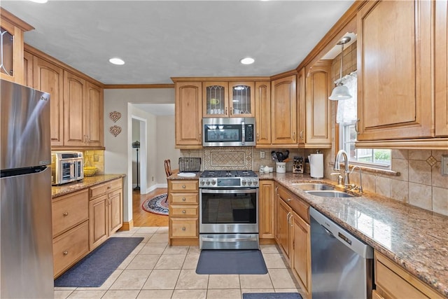 375 Navaho Hollow Rd, Coolbaugh Twp, PA 15438 - kitchen featuring appliances with stainless steel finishes, light tile patterned flooring, decorative backsplash, a sink, and light stone counters