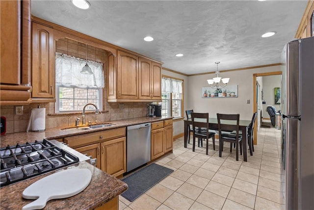375 Navaho Hollow Rd, Coolbaugh Twp, PA 15438 - kitchen featuring appliances with stainless steel finishes, a sink, a chandelier, light tile patterned flooring, and decorative backsplash
