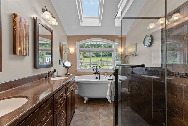 375 Navaho Hollow Rd, Coolbaugh Twp, PA 15438 - full bath featuring a freestanding bath, double vanity, a shower stall, lofted ceiling, and a skylight