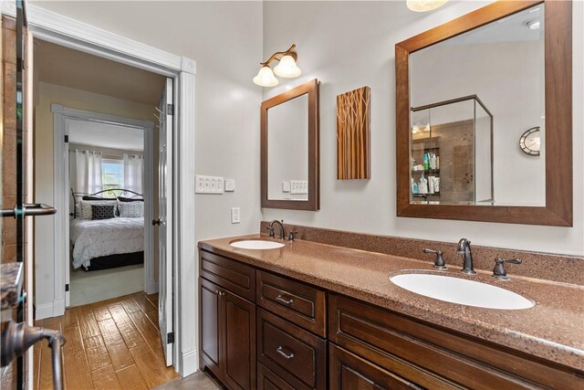 375 Navaho Hollow Rd, Coolbaugh Twp, PA 15438 - full bathroom with double vanity, ensuite bathroom, and wood finished floors
