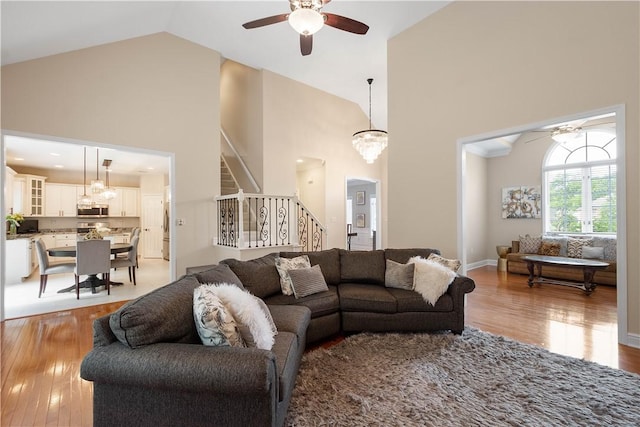 8007 Pressley Ct, Mccandless, PA 15237 - living area featuring a ceiling fan, high vaulted ceiling, stairway, and light wood-style floors